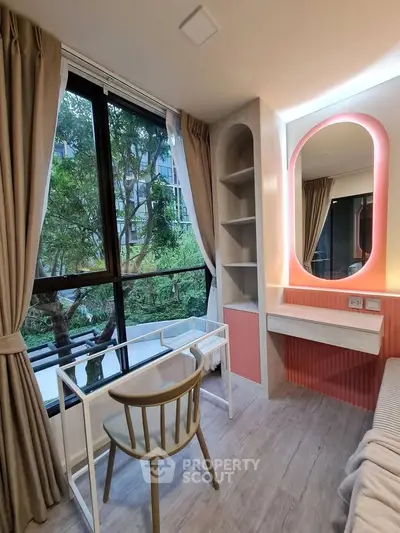 Modern study room with large window and stylish desk overlooking lush greenery.