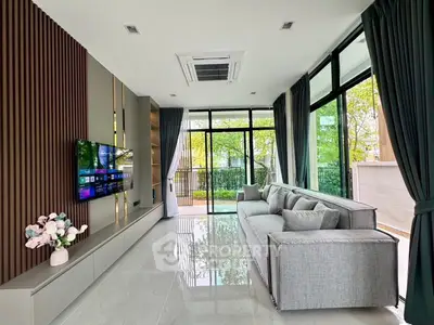 Spacious modern living room with large windows and elegant decor