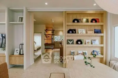 Stylish open-plan living area with modern decor and built-in shelving, perfect for contemporary living.