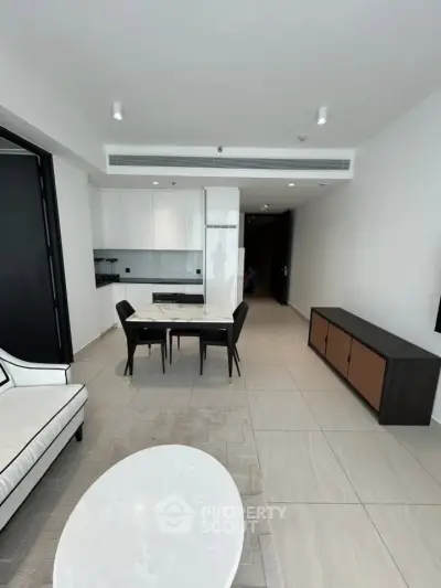 Modern open-plan living room with sleek furniture and minimalist design