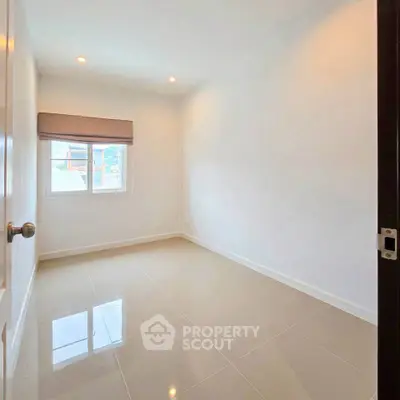 Spacious unfurnished bedroom with natural light and tiled flooring