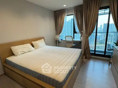 Modern bedroom with city view and large windows, featuring a comfortable bed and stylish decor.