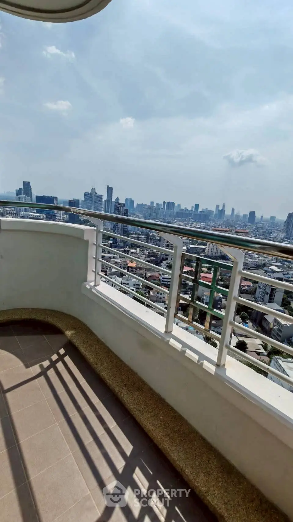 Stunning high-rise balcony with panoramic city skyline view, perfect for urban living enthusiasts.