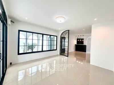 Spacious modern living room with elegant glass doors and natural light