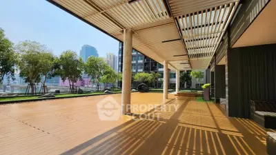 Spacious outdoor terrace with modern pergola and city view, perfect for relaxation and gatherings.