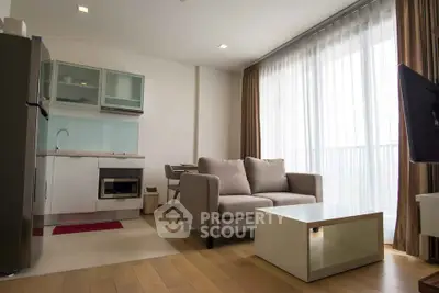 Modern living room with open kitchen and large windows in a stylish apartment