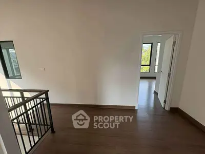 Spacious hallway with wooden flooring and natural light