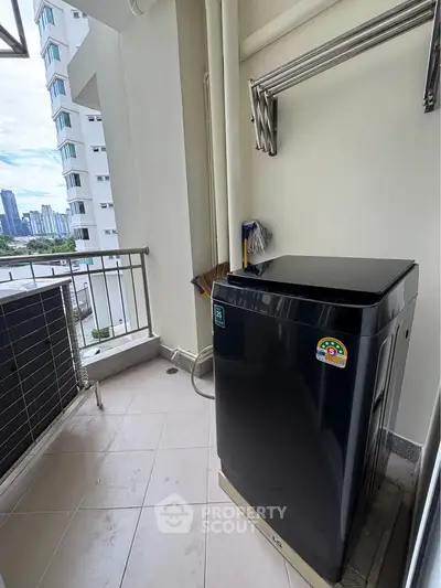 Modern balcony with city view and washing machine, perfect for urban living convenience.