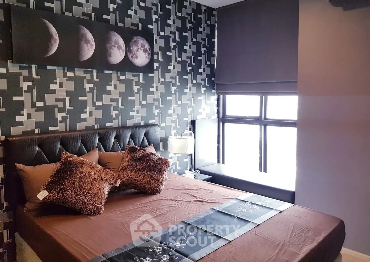 Stylish bedroom with modern decor and large window for natural light.