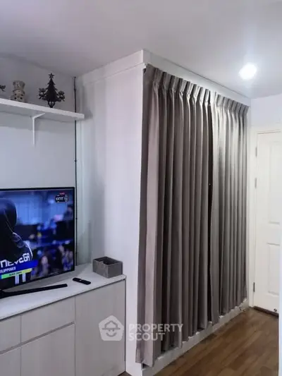 Cozy living room corner with TV and elegant curtains