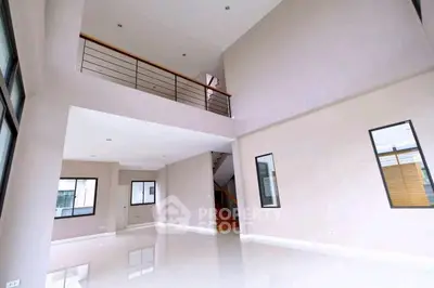 Spacious modern living room with high ceilings and large windows