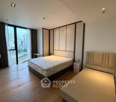 Spacious modern bedroom with city view and elegant furnishings