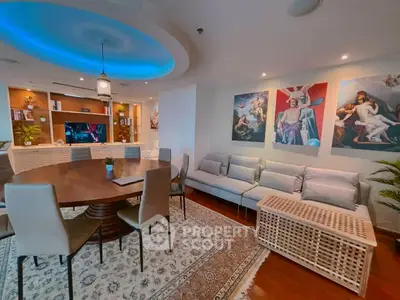 Luxurious living room with modern decor, elegant dining area, and artistic wall paintings.