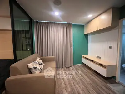 Modern living room with stylish sofa, wooden flooring, and elegant curtains in a cozy apartment.