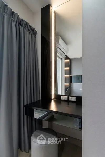 Modern bedroom with sleek vanity and elegant curtains, featuring contemporary design and ambient lighting.