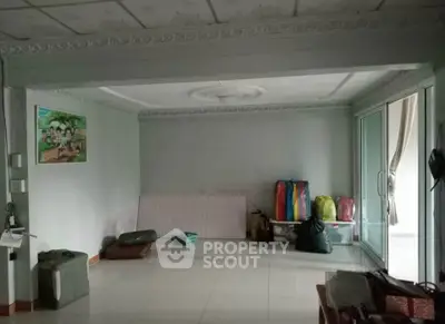 Spacious unfurnished room with tiled floor and large windows, ideal for customization.