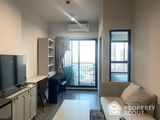 Modern studio apartment with open layout kitchen, cozy living area, and balcony access, featuring ample natural light and a sleek design.