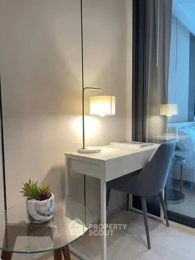 Modern study nook with sleek desk and lamp in stylish apartment