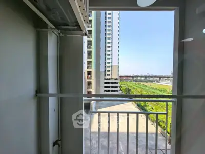 Modern apartment balcony with city view and ample natural light.
