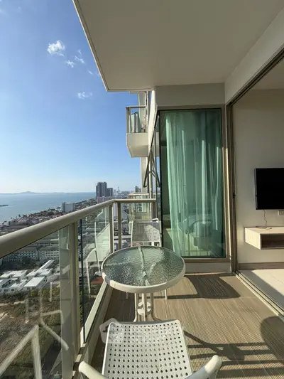Stunning high-rise balcony with panoramic city and sea views, perfect for relaxation and entertainment.