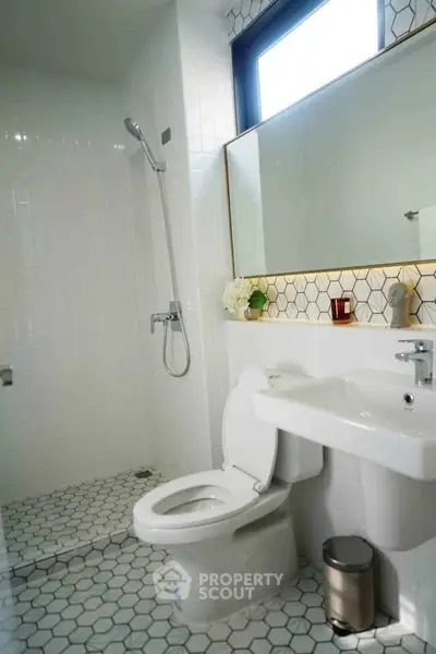 Modern bathroom with sleek fixtures and hexagonal tile flooring