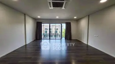 Spacious empty living room with large windows and modern flooring