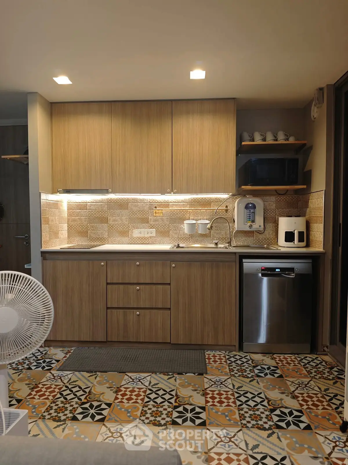 Modern kitchen with stylish cabinets and patterned tile flooring