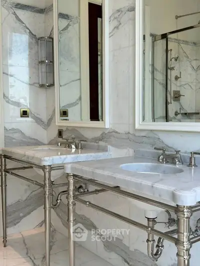 Luxurious marble bathroom with dual sinks and elegant fixtures