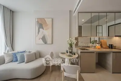 Modern living room with stylish furniture and open kitchen layout, featuring elegant decor and natural light.