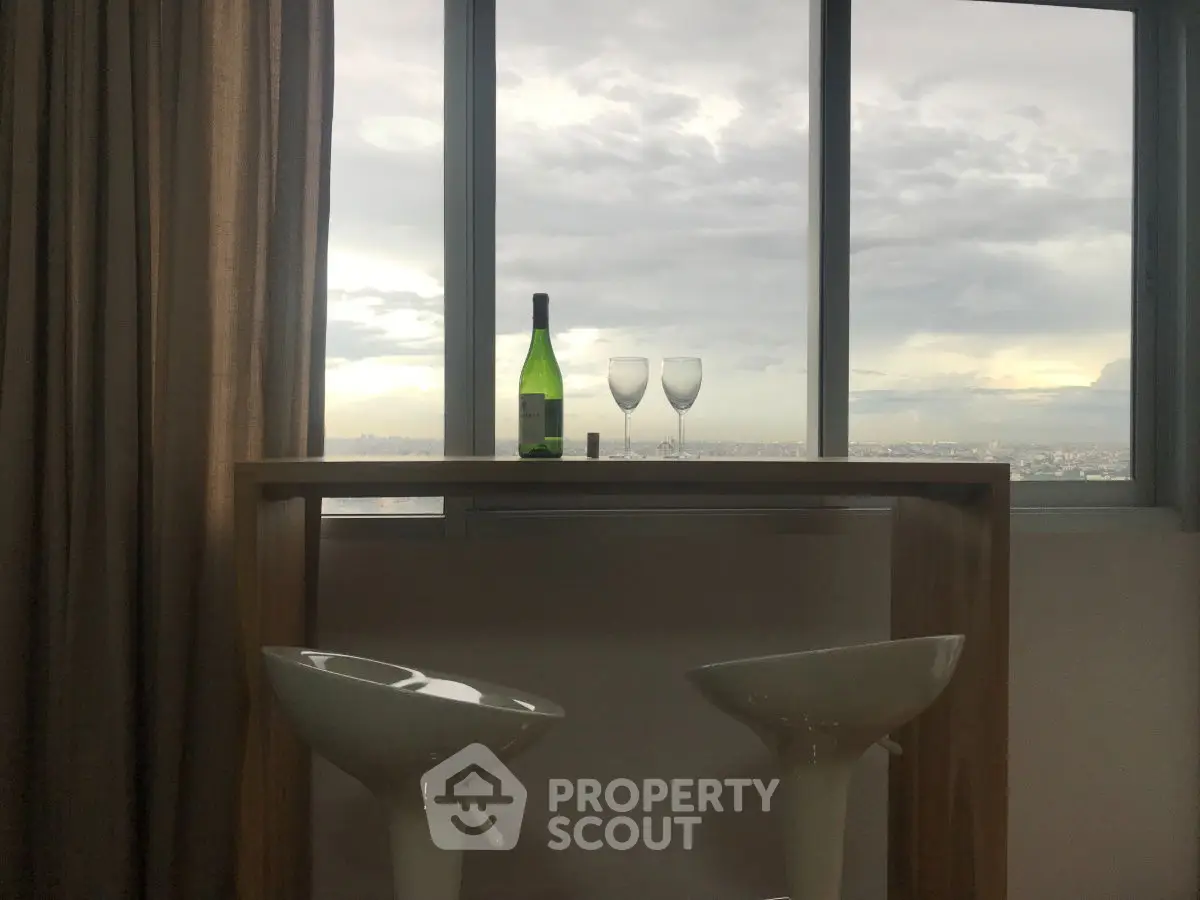Stylish high-rise apartment with stunning city view and modern bar setup.