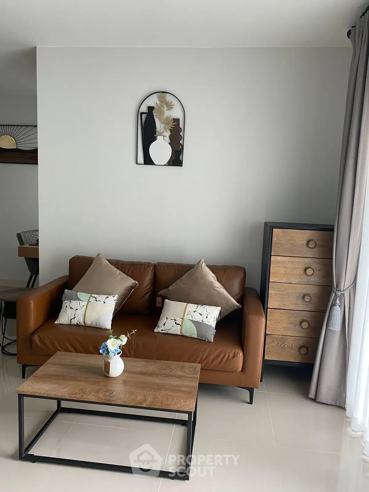 Modern living room with stylish brown sofa, wooden coffee table, and elegant decor.