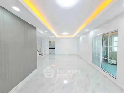 Spacious modern living room with sleek marble flooring and ambient lighting
