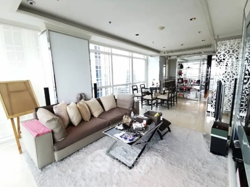 Luxurious living room with modern decor and panoramic city views.