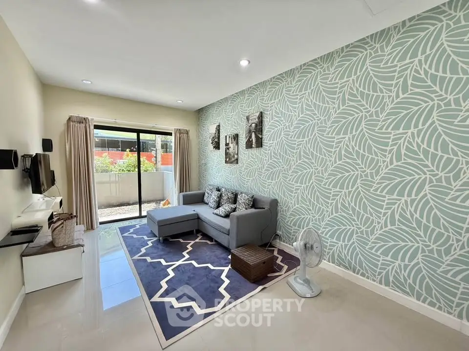 Stylish living room with modern decor and natural light, featuring a cozy sectional sofa and elegant wallpaper.