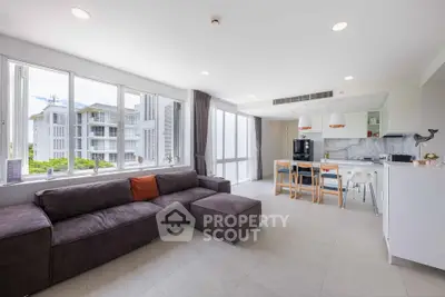 Spacious modern living room with open kitchen and large windows