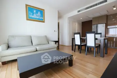 Modern living room with elegant dining area and sleek kitchen appliances