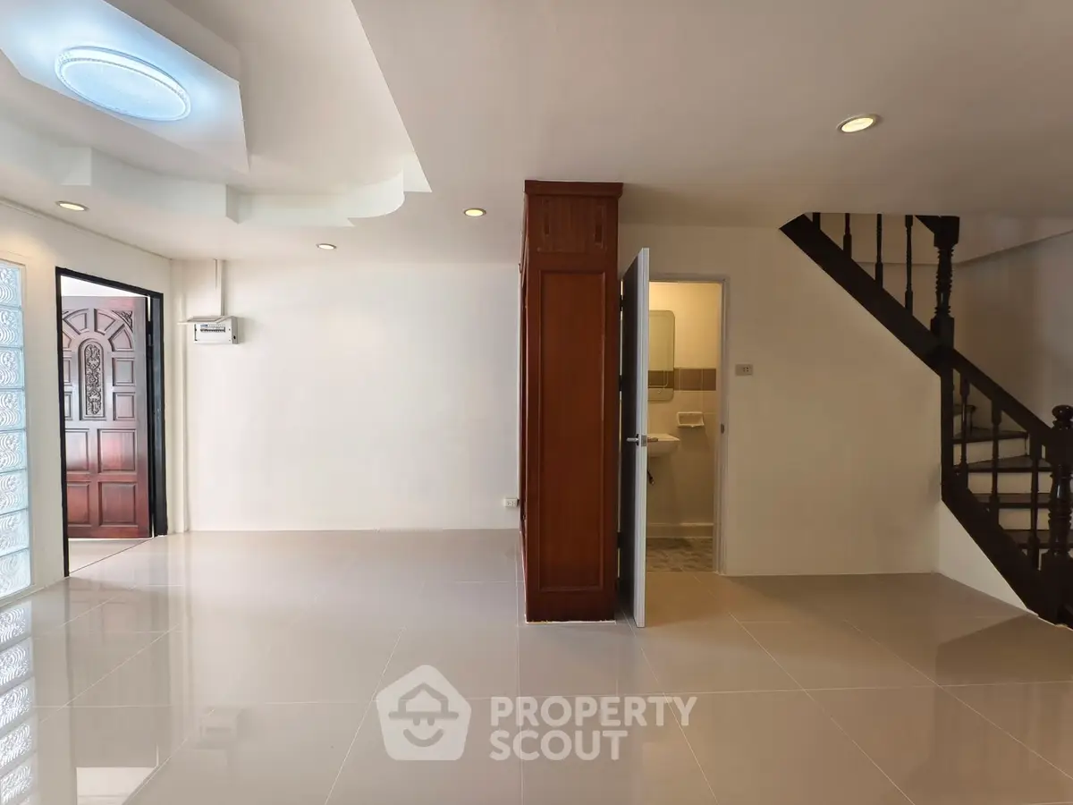 Spacious interior with modern staircase and open layout, perfect for customization.
