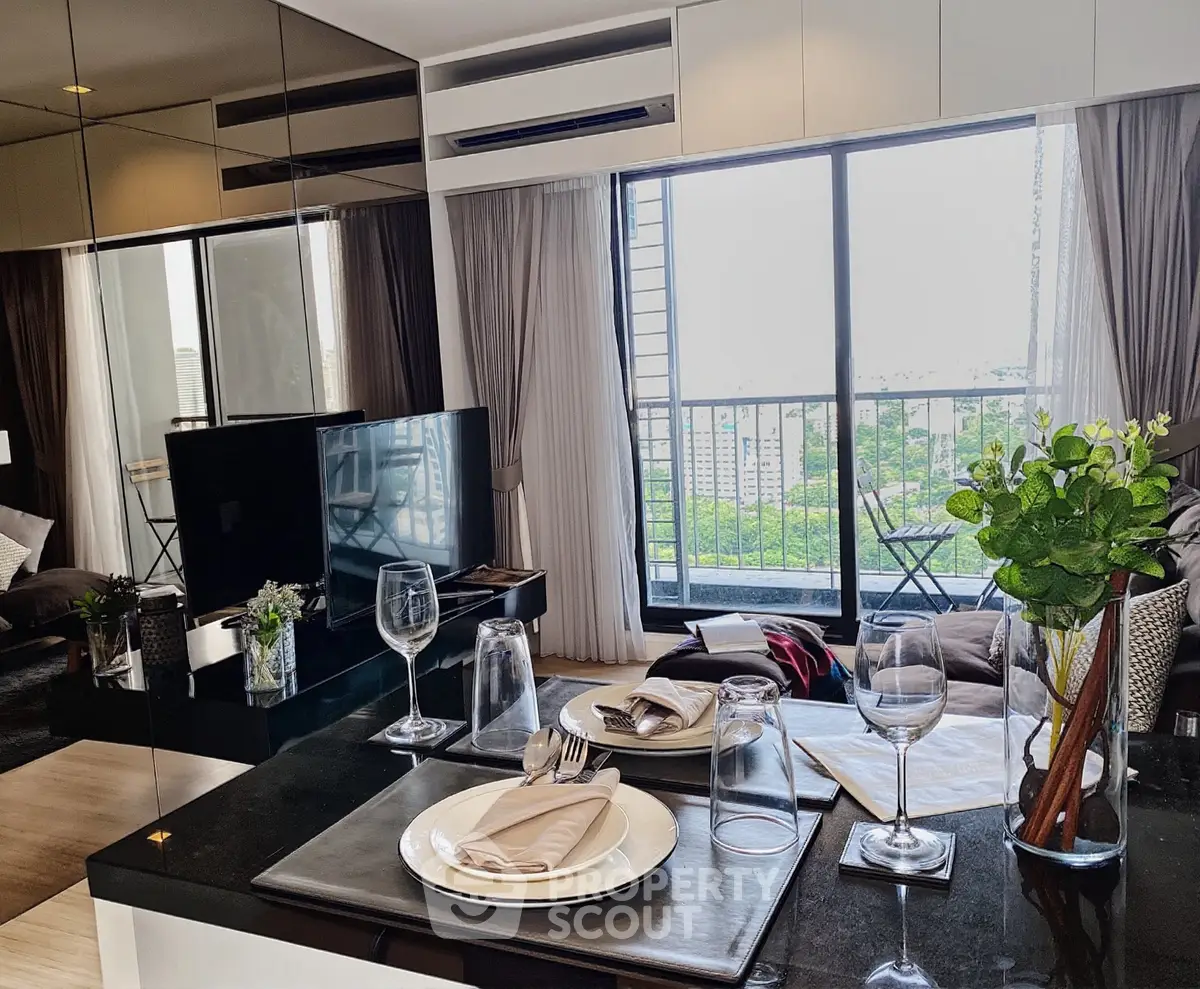 Modern living room with elegant dining setup and balcony view