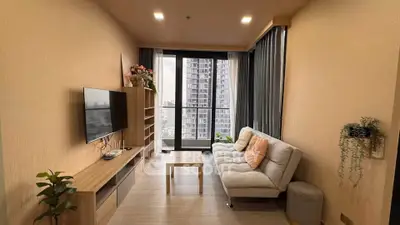 Modern living room with cozy sofa and city view balcony