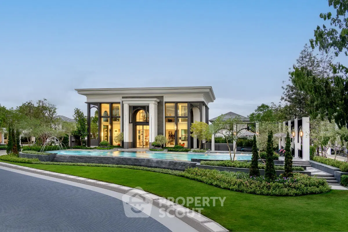 Luxurious mansion with grand entrance and lush landscaping