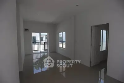 Spacious empty room with large windows and glossy tiled floor, perfect for customization.