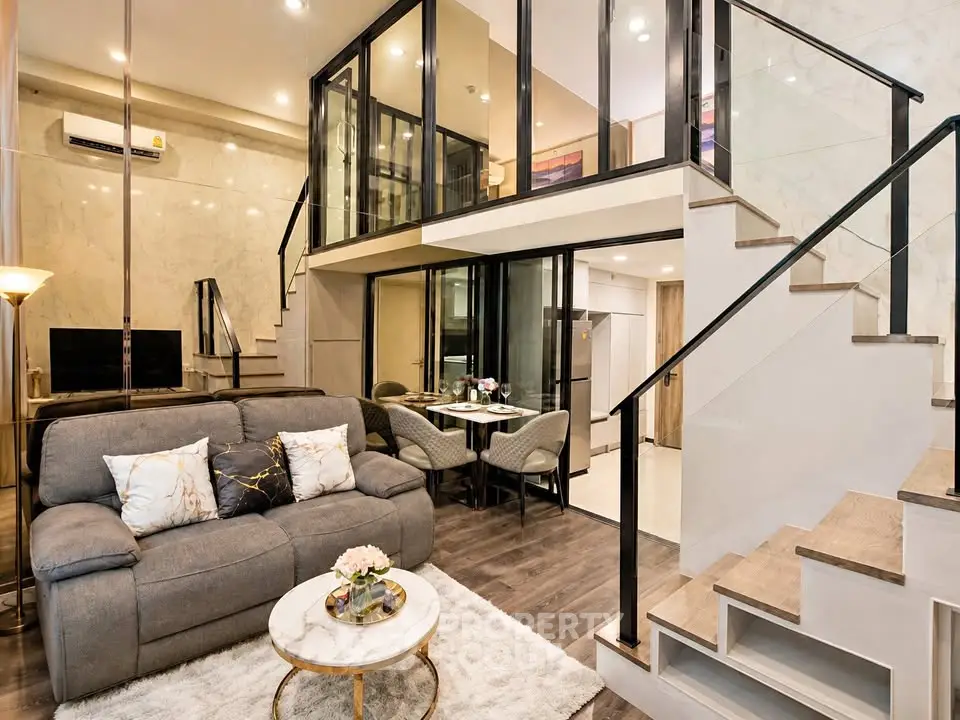 Luxurious modern living room with mezzanine, elegant decor, and stylish furniture in a contemporary apartment.