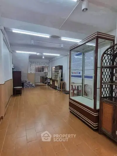 Spacious interior with tiled flooring and display cabinets, ideal for commercial use.