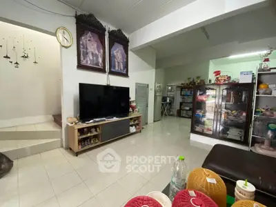 Spacious living room with modern decor and large TV, perfect for family gatherings.