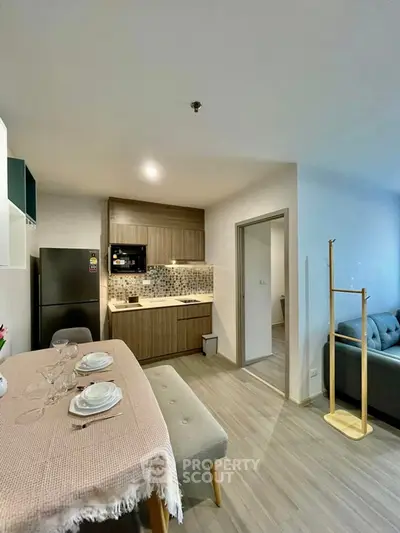 Modern open-layout kitchen and dining area with stylish decor and cozy living space.