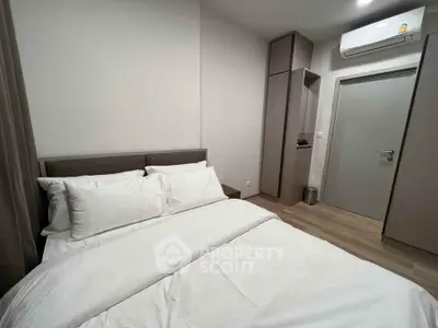 Modern bedroom with cozy bed and sleek air conditioning unit