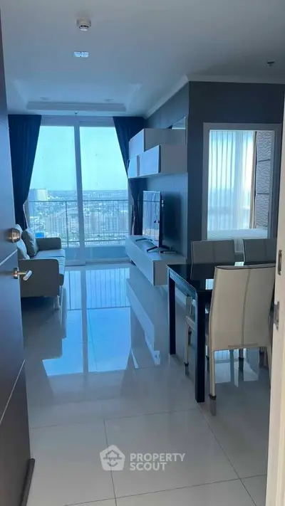 Modern living room with sleek furniture and stunning city view through large windows.