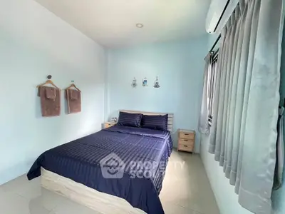 Cozy bedroom with modern decor and natural light, featuring a comfortable bed and stylish furnishings.