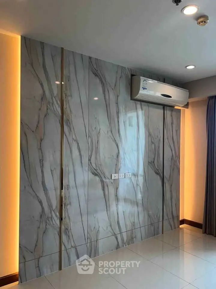 Modern interior with marble accent wall and air conditioning unit, perfect for luxury living.
