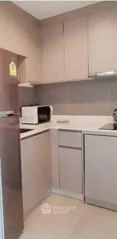Modern compact kitchen with sleek cabinetry and built-in appliances